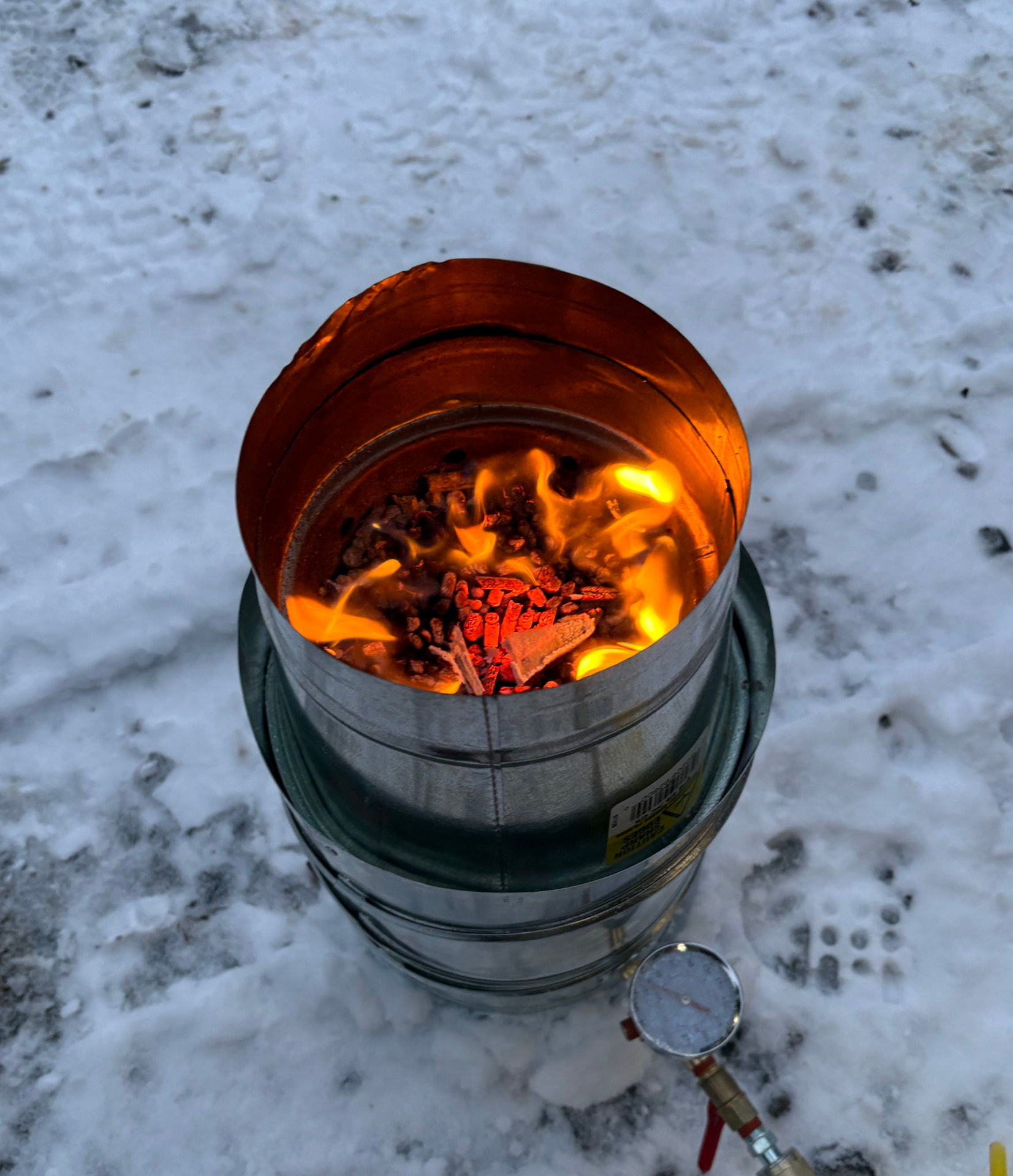 Small-scale pyrolysis reactor burning biomass pellets in the snow
